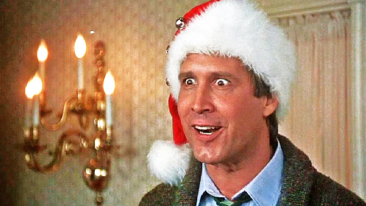Christmas Vacation screen shot featuring chevy chase wearing a Santa Cap