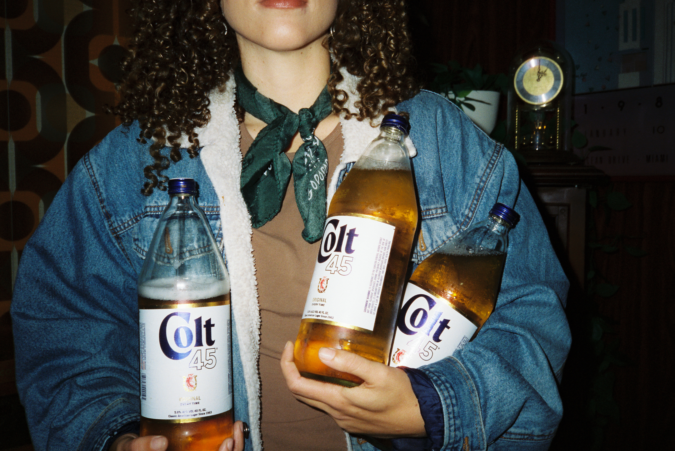woman carrying 3 large bottles of colt 45 beer